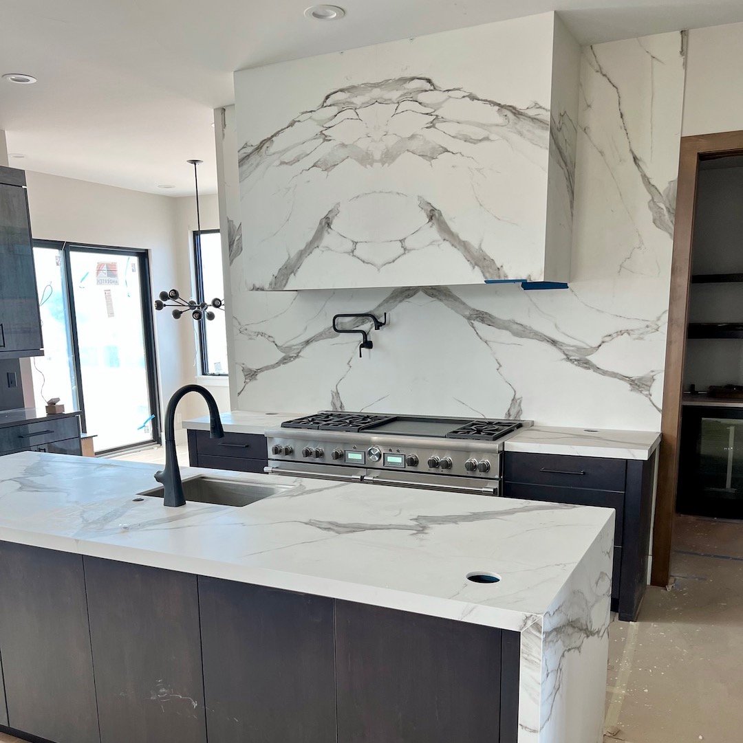 book matched wrapped hood vent in kitchen